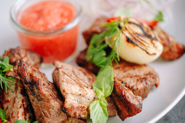 meat marinated for barbecue grilled and served on a white plate