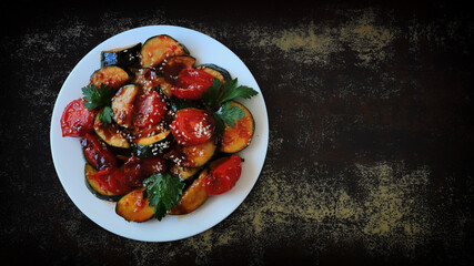 Baked vegetables with sesame seeds on a white plate. Vegan lunch. Healthly food.