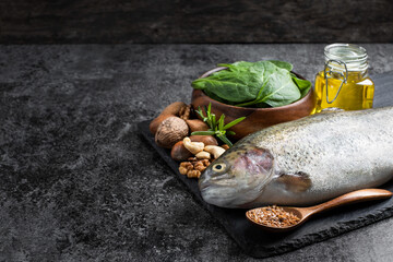 Set of food with fats and omega-3 on dark background