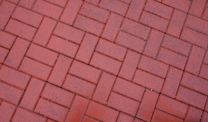 The texture of paving slabs.
Street paved with burgundy tiles
