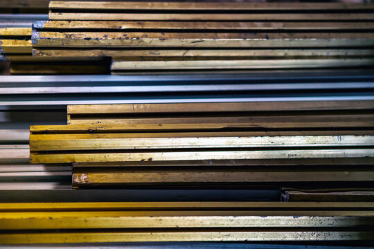 metal products corners in the mass in side view, metallurgy, steel, blurred background - Powered by Adobe