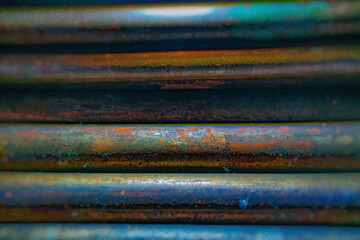 metal rods with rust in mass, side view, metallurgy, steel, blurred background