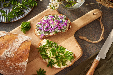 Sourdough bread with wild edible spring plants - young goutweed leaves, purple dead-nettle and...