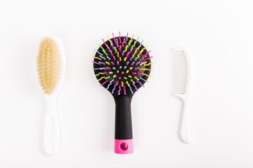 Set of hair combs on the white background. Hairbrushes, different types of combs. Minimalist flat lay.