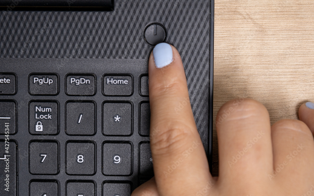 Wall mural black keyboard of a handheld photographed diagonally in detail the power key on and off with the fin