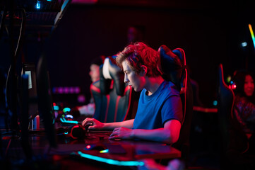 Training bootcamp for professional esports players. Young cyber-athletes play an online shooter...