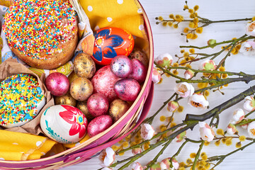 Fototapeta premium Closeup view of easter cakes and eggs in basket.