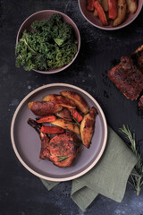 Oven Roasted Rack of Pork served with potato wedges.