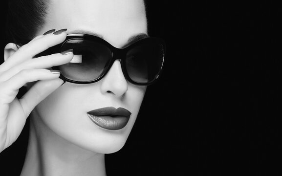Monochrome stylish woman face with trendy sunglasses. High fashion portrait.