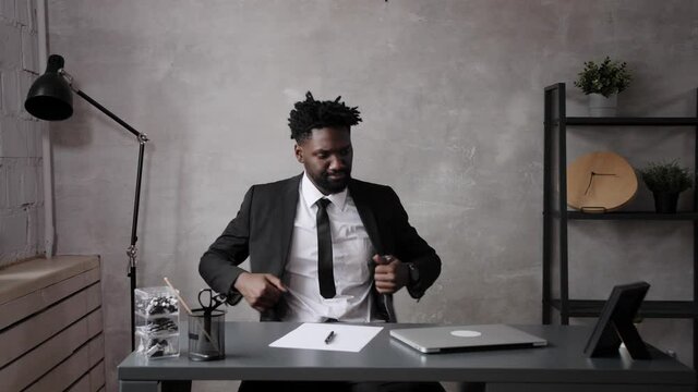 black business man comes to work in the office. The begining of the work day