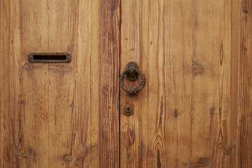 old wooden door with lock and hole to put the letter