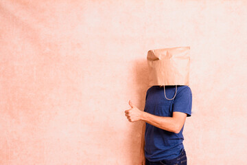 Man with paper bag on his head satisfied with his personal achievement, isolated.