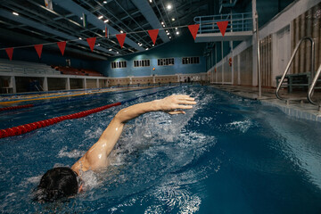 man swimming in pool