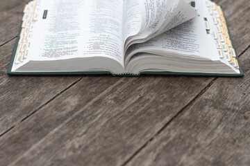 Open bible on rustic weathered wood