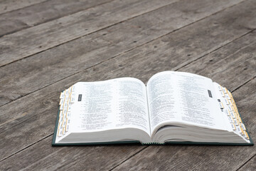 Open bible on rustic weathered wood