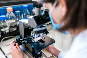 Female Scientist Using Microscopy in Laboratory closeup