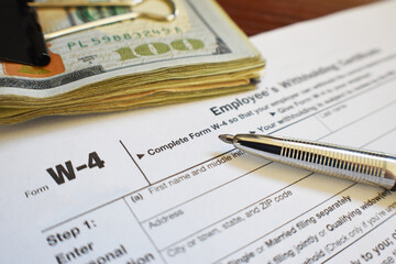 Tax Form W-4 Close Up With Pen And Money 