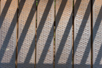 close up of metal slats and diagonal shadows