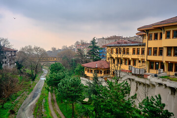 29.03.2021. Bursa Turkey. irgandi bridge and city library in bursa with yellow color painting. Photo taken rainy day and overcast sky including river coming from ulu mountain (uludag)