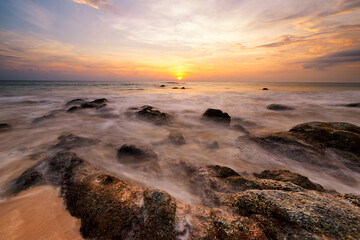 Obraz premium Scene of sea wave and sunset at Naithon beach