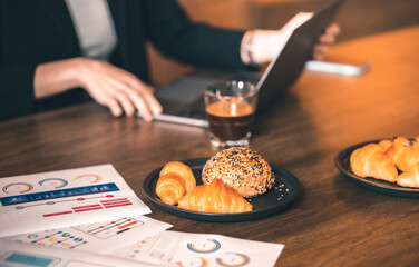 young asian woman and caucasian man Business people Working discuss finding new strategy solution.People discussion business plan using laptop at cafe.