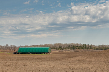 Green Equipment Shelter in a Farmers Field Early Spring