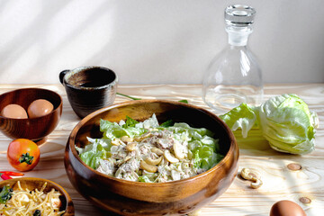 Tuna Salad and Spicy Spaghetti with ingredient  and black coffee on nature wooden backdrop