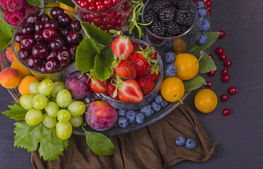 summer fresh berries of different types on a black background