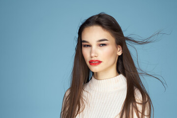 Pretty woman red lips white jacket attractive look close-up blue background