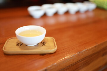 Tea time. Green tea cup  on the white desk.