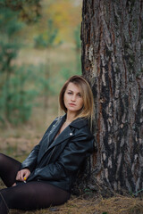 Beautiful woman portrait in forest in autumn.