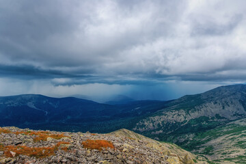 Rainy weather in the mountains Kuznetsky Alatau mountains from large stones of kurum and clouds with rain