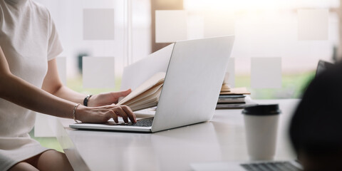 Fototapeta premium Businesswoman working on computer at table in office, closeup. Banner design