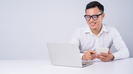 Asian businessman using laptop on white background