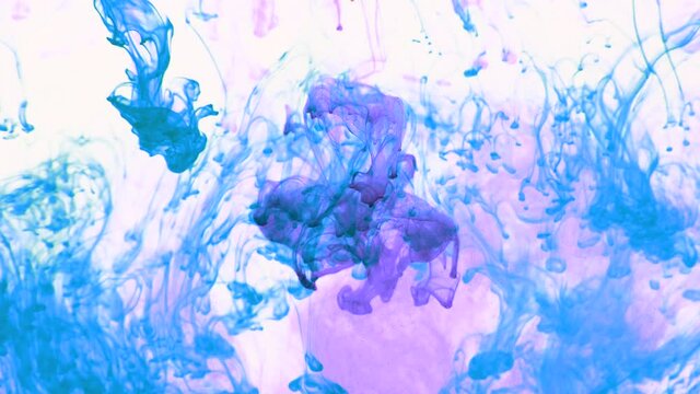 4K footage of colorful ink drops in water, isolated abstract background. Pouring ink in water. Underwater paint mix. Slow psychedelic dye swirls, colored smoke explosion. Splashing, floating liquid