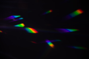Blur colorful warm rainbow crystal light leaks on black background. Defocused abstract retro film...
