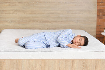 Morning of little boy sleeping on comfortable mattress