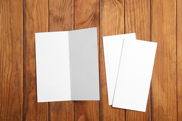 Blank brochures on wooden background
