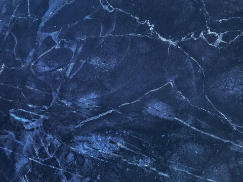 Texture of navy blue marble with lines of pattern, macro background. Dark azure stone backdrop from mineral tile