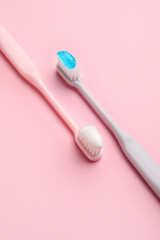 Tooth brushes on color background