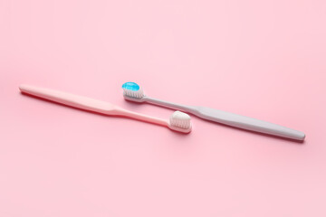 Tooth brushes on color background