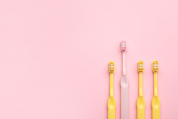 Tooth brushes on color background