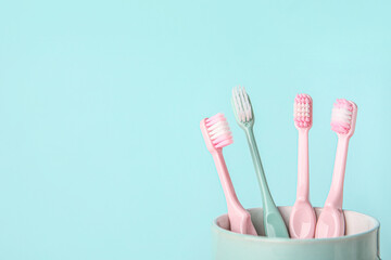 Tooth brushes on color background
