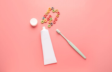 Toothbrush with paste and tooth made of cornflakes on color background