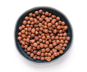 Bowl with chocolate corn balls on white background