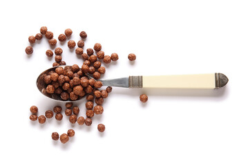 Spoon with chocolate corn balls on white background