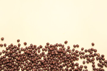 Chocolate corn balls on color background