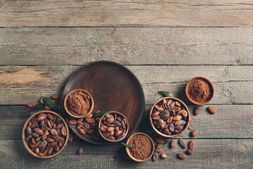 Composition with cocoa beans on wooden background