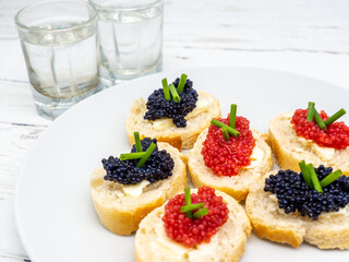 fish roe appetizers and glasses of vodka