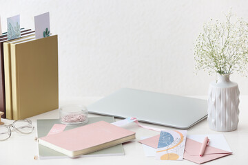 Books, laptop and stationery on table
